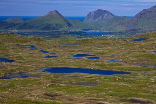 Scenic panorama of lakes and mountains on Lofoten islands in Norway on sunny summer day