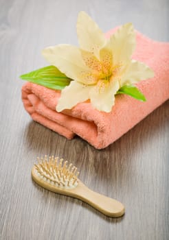 flower on pink towel with hairbrush