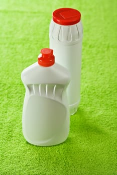 two bottles on green background
