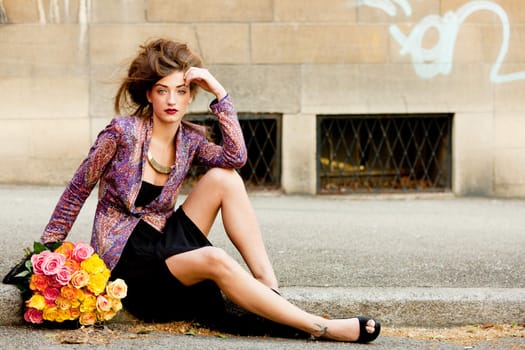 attractive young woman with pink roses outdoor on street