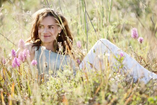 adult brunette woman smiling in summertime outdoor nature