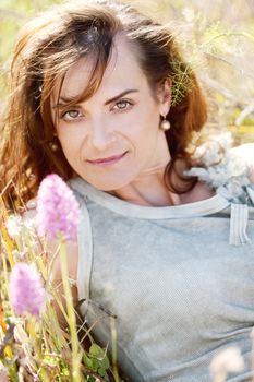 adult brunette woman smiling in summertime outdoor nature