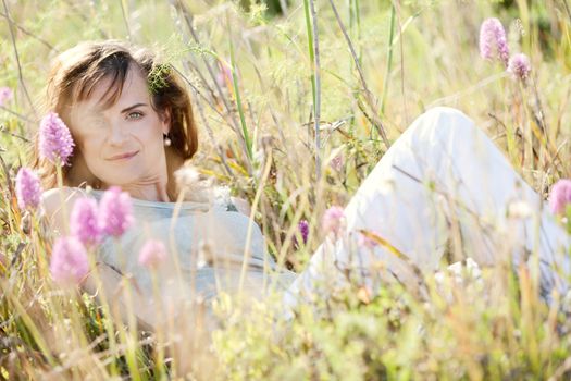 adult brunette woman smiling in summertime outdoor nature