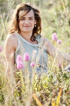 adult brunette woman smiling in summertime outdoor nature