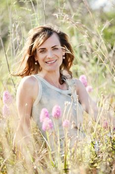 adult brunette woman smiling in summertime outdoor nature