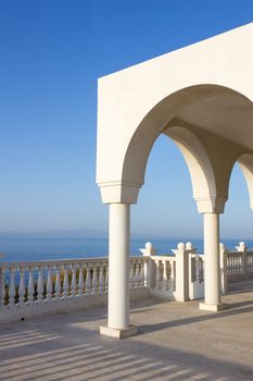 View over the Aegean Sea from the porch or terrace with arches and columns of orthodox church Profitis Ilias in Keratea, near Lavrio, in East Attika, Greece.