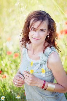 adult brunette woman smiling in summertime outdoor nature