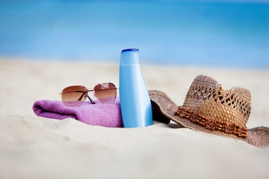 sunprotection objects on the beach in holiday sunglasses hat suncare
