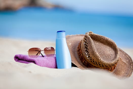 sunprotection objects on the beach in holiday sunglasses hat suncare