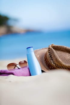 sunprotection objects on the beach in holiday sunglasses hat suncare