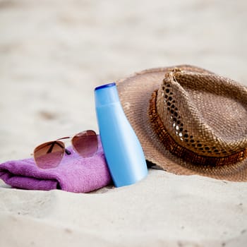 sunprotection objects on the beach in holiday sunglasses hat suncare