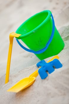 plastik colorful toys in sand on beach in summer holiday vacation