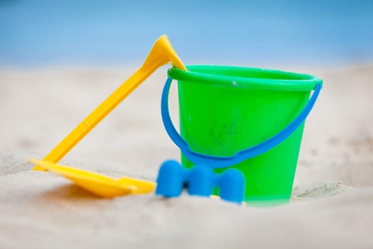 plastik colorful toys in sand on beach in summer holiday vacation