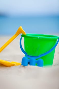 plastik colorful toys in sand on beach in summer holiday vacation