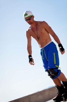 young man with inline skates in summer outdoor rollerblades skater
