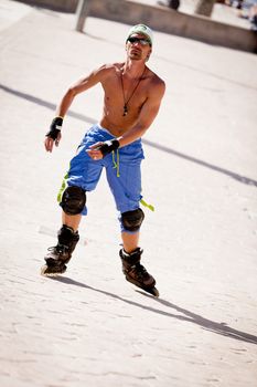 young man with inline skates in summer outdoor rollerblades skater