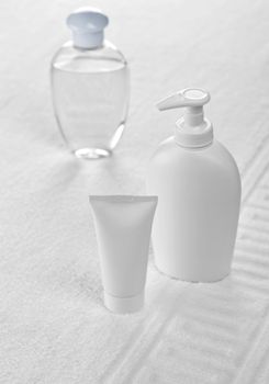 plastic bottles on white cotton towel towel