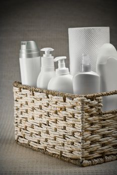 bottles and paper towel in basket