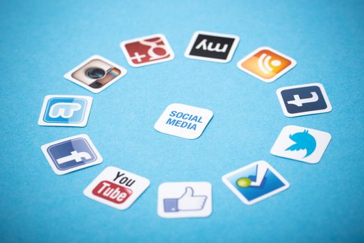 Kiev, Ukraine - June 11, 2013 - A logotype collection of well-known social media brands printed on paper and placed around on a blue background.