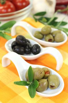 Olives with olive leaves on a spoon