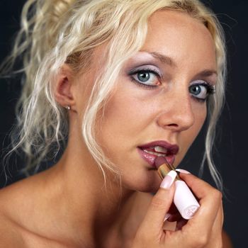 Young Woman Applying Lipstick. Model Released