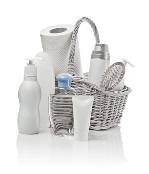 basket with cosmetics, paper towel and hairbrush