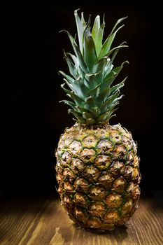 one pineapple on wooden board