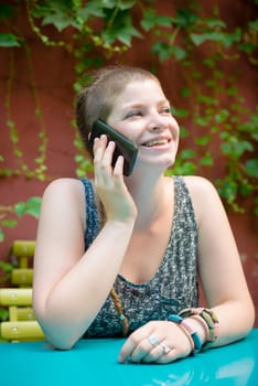 beautiful stylish modern young woman on the phone in the city