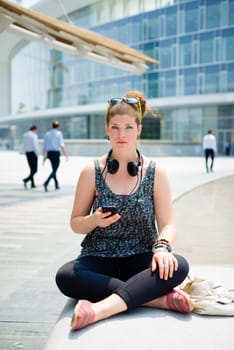 beautiful stylish modern young woman on the phone in the city