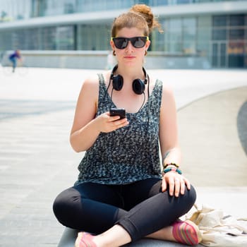 beautiful stylish modern young woman on the phone in the city