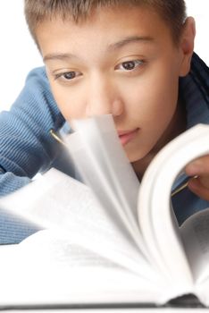 Photo of the young man turning the leaves of the book