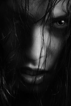 BW portrait of the angry witch-woman with wet hairs
