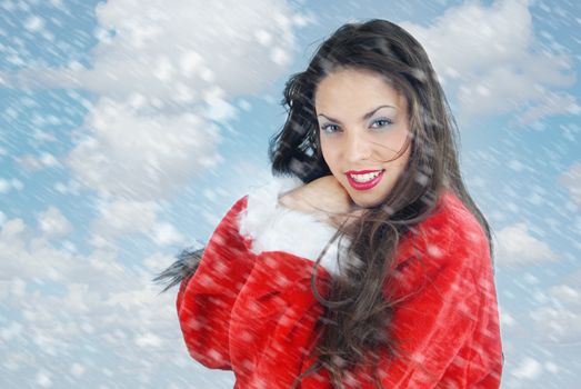 Smiling lady outdoors and snowstorm before Christmas