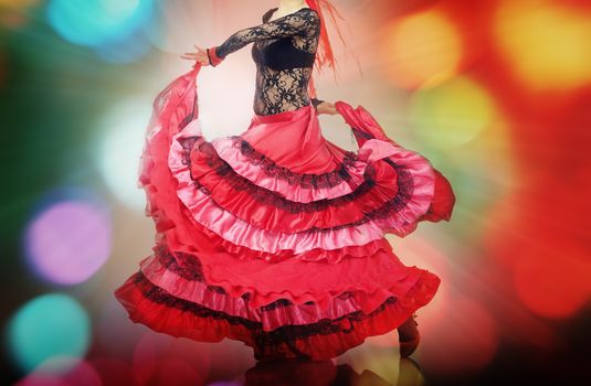 Woman dancing flamenco on background with disco illumination