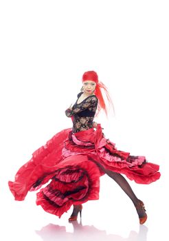 Lady in Gypsy costume dancing flamenco on a white background