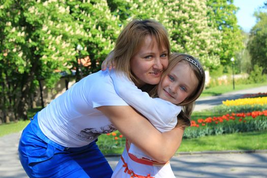 image of mother and daughter are hugging one another