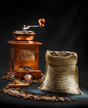 dark composition of coffee mill and bag