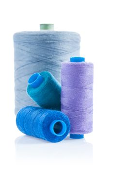four sewing bobbins isolated
