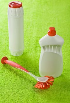 bottles and brash on green towel