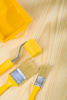 brushes and roller with paint can