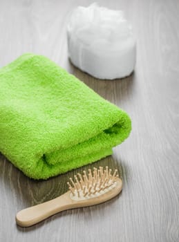 hairbrush and bath sponge with towel