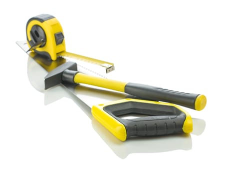 measuring tape and hammer on saw