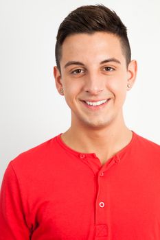 Young and handsome guy posing over white background