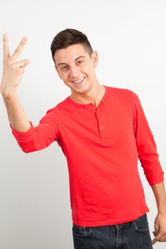 Young and handsome guy posing over white background