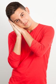 Young and handsome guy posing over white background