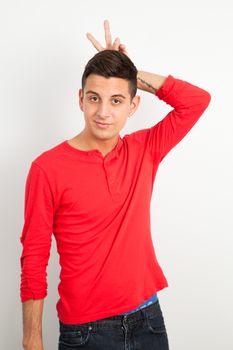 Young and handsome guy posing over white background