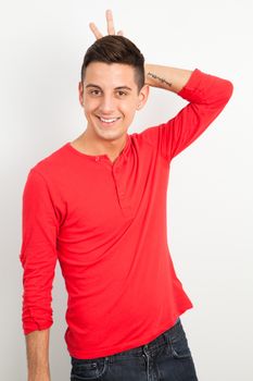 Young and handsome guy posing over white background