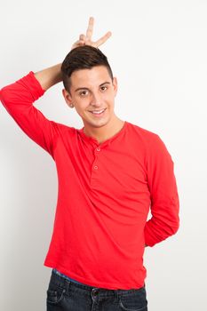 Young and handsome guy posing over white background