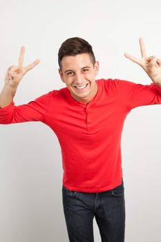 Young and handsome guy posing over white background