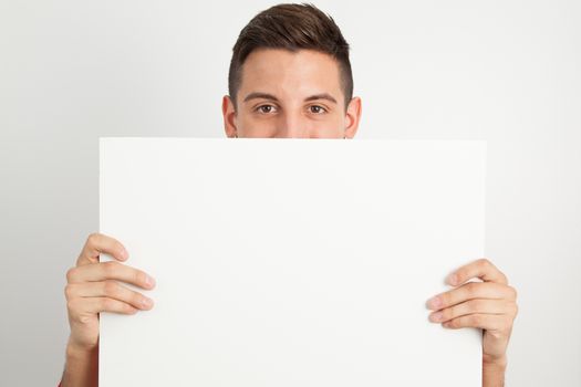 Young and handsome guy posing over white background